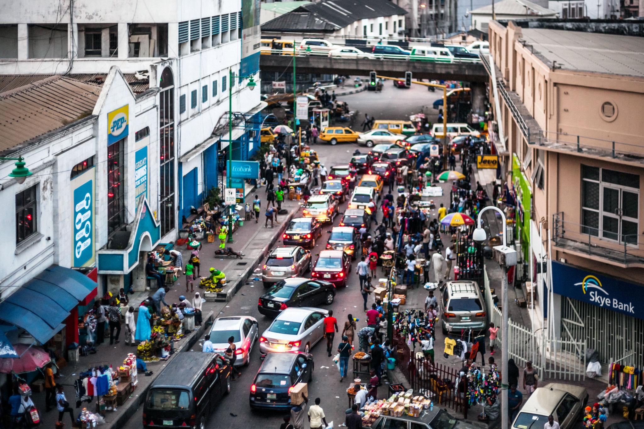 A bustling African market reflects the continent’s economic activity, highlighting the gap between available capital and job creation on the ground.